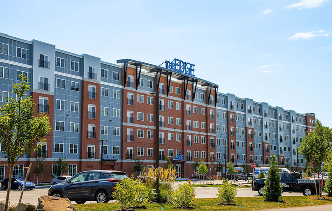 A large apartment complex with a blue sign on the side.