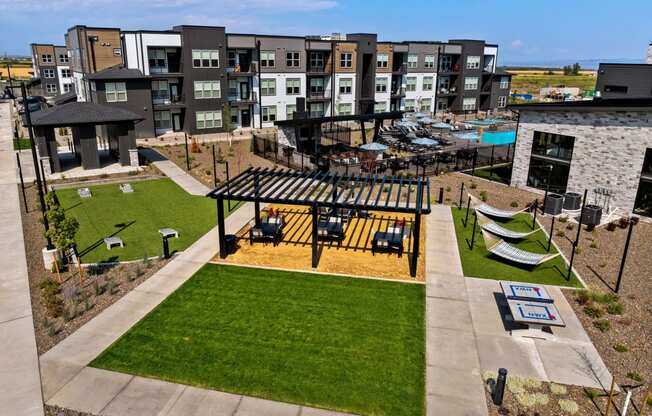 an aerial view of an apartment complex with a picnic area and lawn