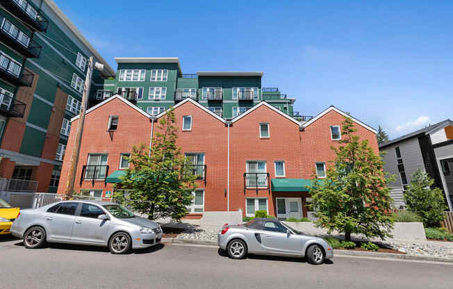 a view from the street of the property building with a green awning and trees at Sedona Apartments, Washington