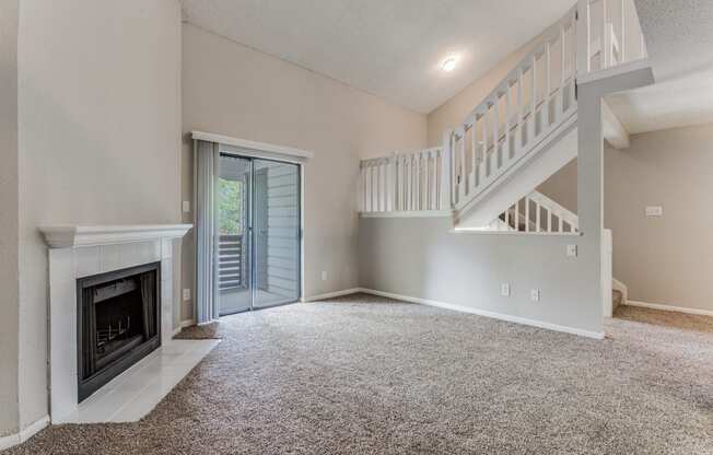 a living room with a fireplace and a staircase