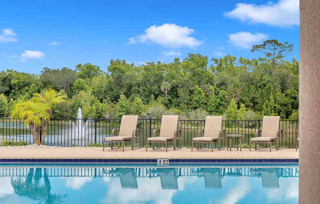 Pool with lake view at Bermuda Estates Apartments in Ormond Beach, FL
