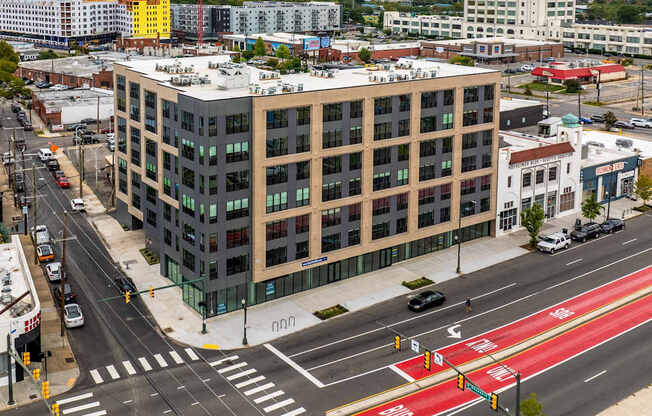 A multi-story building with a red crosswalk in front of it.