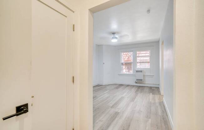 A white door with a black handle is on the left side of the image.