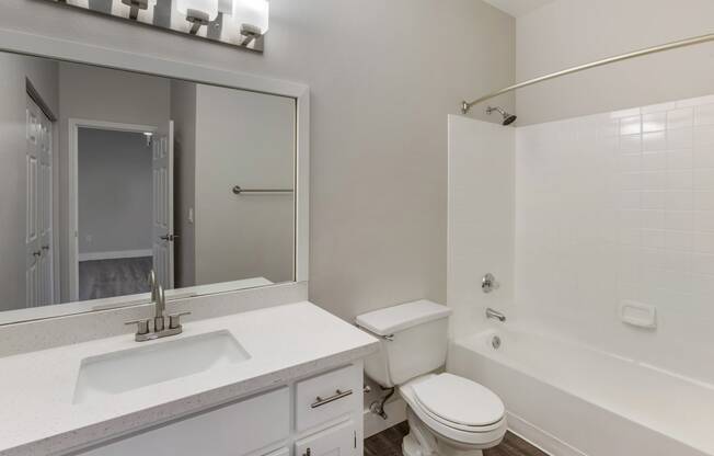 Experience luxury with our bathroom boasting a comfortable bathtub for your relaxation at Boulders at Lookout Mountain Apartment Homes, Phoenix Arizona