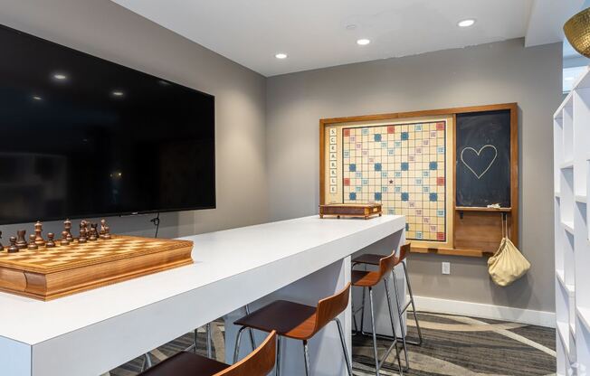 a game room with a chess board and a long white table