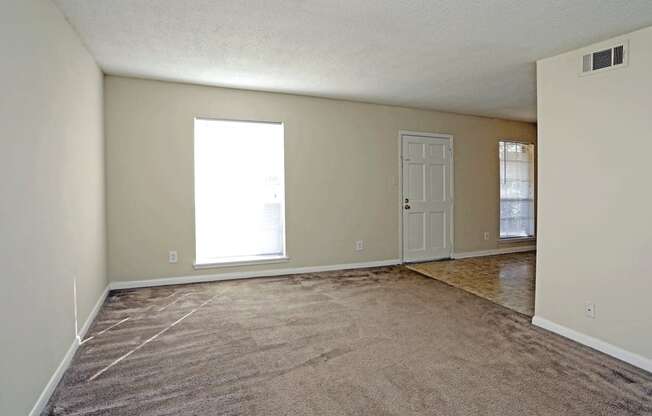 Living room with plush carpeting and window