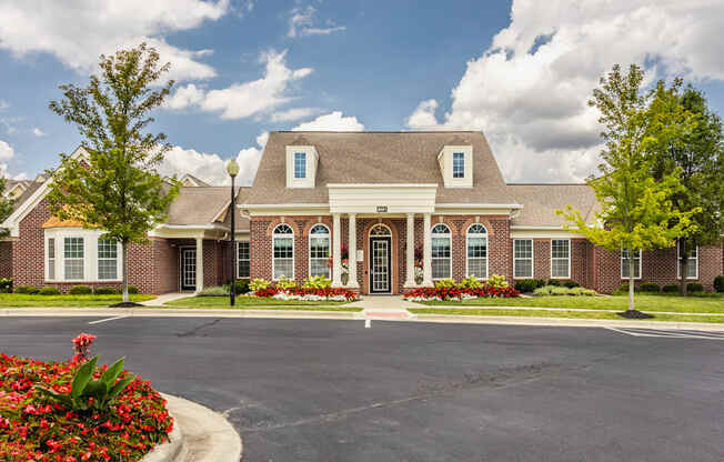a large brick house with a driveway in front of it