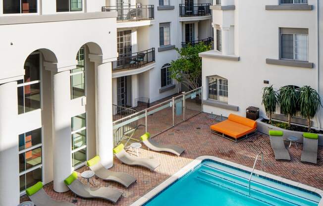 Pet-Friendly Apartments in Los Angeles, CA - The Preston Sparkling Pool with Lounge Chairs