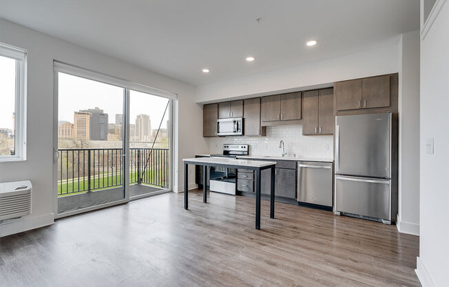 Open concept kitchen with brown cabinets and stainless steel appliances