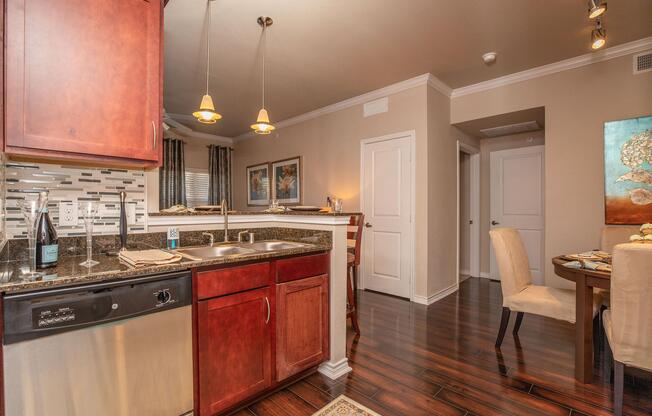 a modern kitchen with stainless steel appliances and wooden cabinets