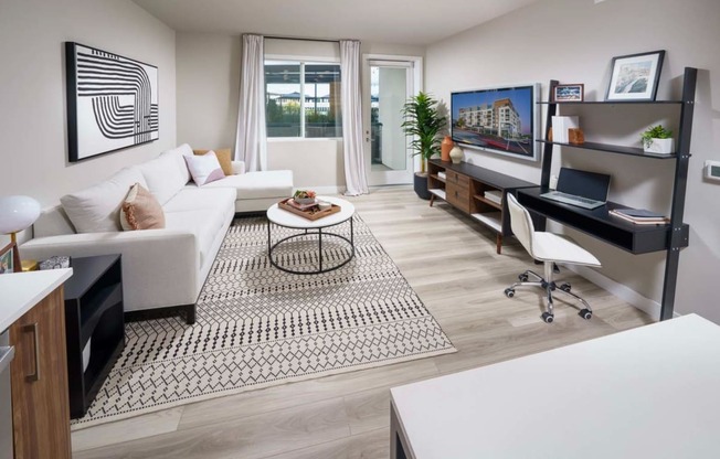 Furnished Living Room with Plank Luxury Flooring, Door to Patio and a Window at NoMa Apartments, California, 94596