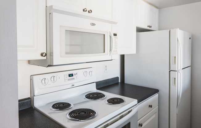 Upgraded white cabinetry and appliances and granite-look counters in select NW tower homes