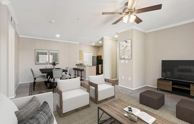 a living room with couches and chairs and a tv