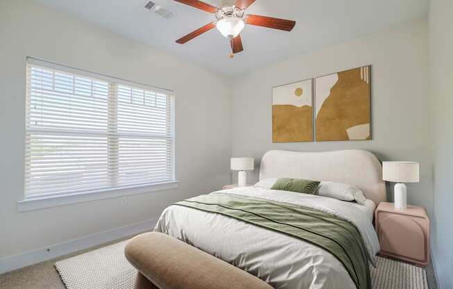 a bedroom with a bed and a ceiling fan