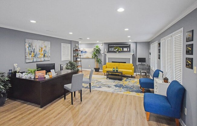 A modern living room with a fireplace and a blue armchair.