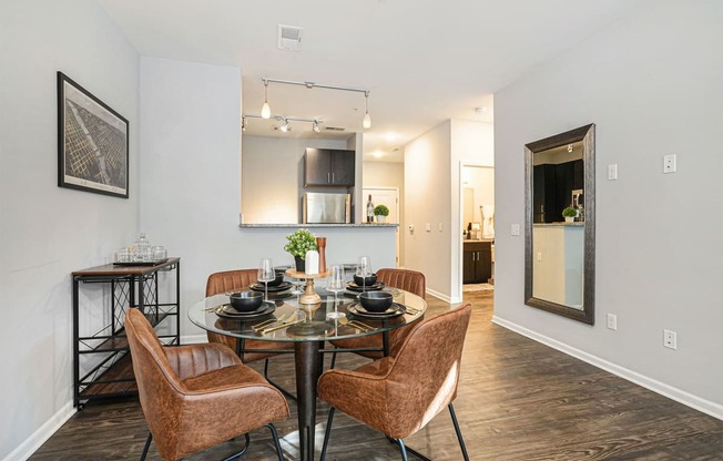 a dining room with a glass table and chairs