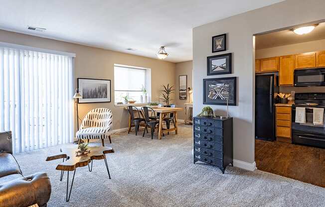 the view of a living room with a dining room and a kitchen