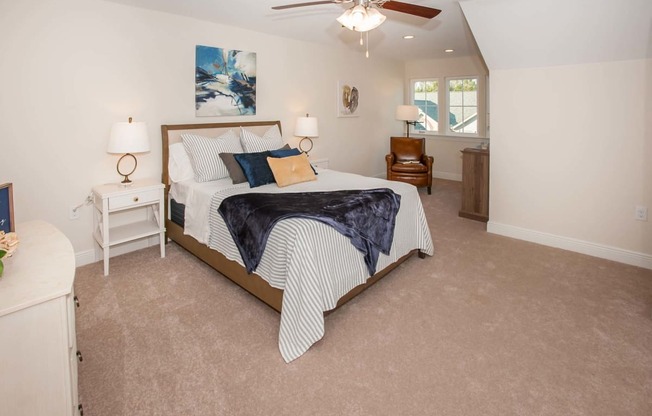 a bedroom with a bed and a ceiling fan