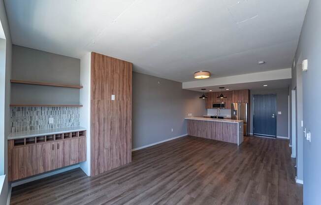 A room with wooden floors and a counter with a sink.