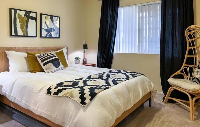 a bedroom with a white comforter
