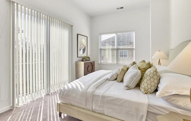 a bedroom with a large bed and a large window