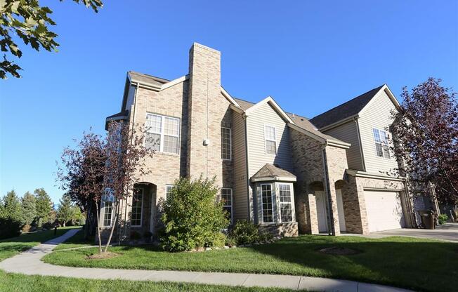 Exterior view of Stone Ridge townhomes with private entrance and attached garage