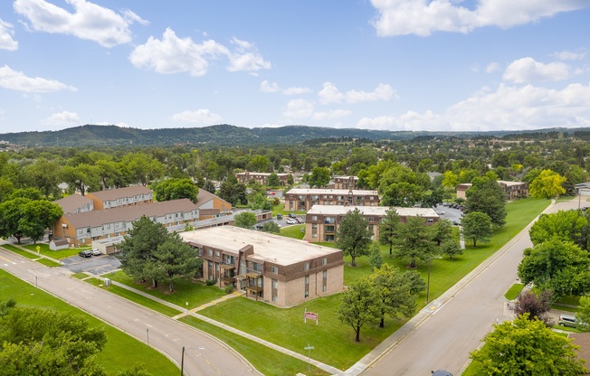 A view of a street with cars and buildings.