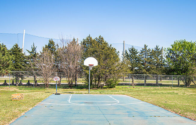 A basketball court with a net and a basketball hoop.
