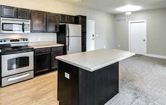 Kitchen with sophisticated black counter tops at Tamarin Ridge in Lincoln, NE