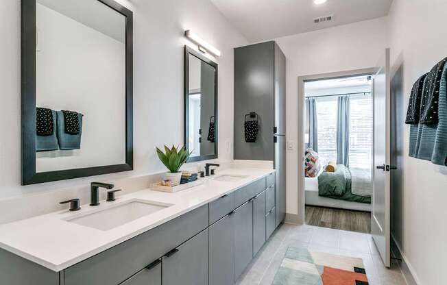A bathroom with a white sink and a mirror above it.