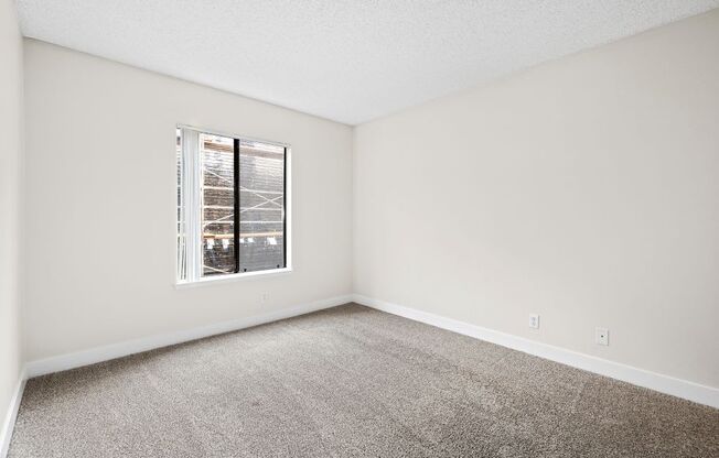 a bedroom with a large window