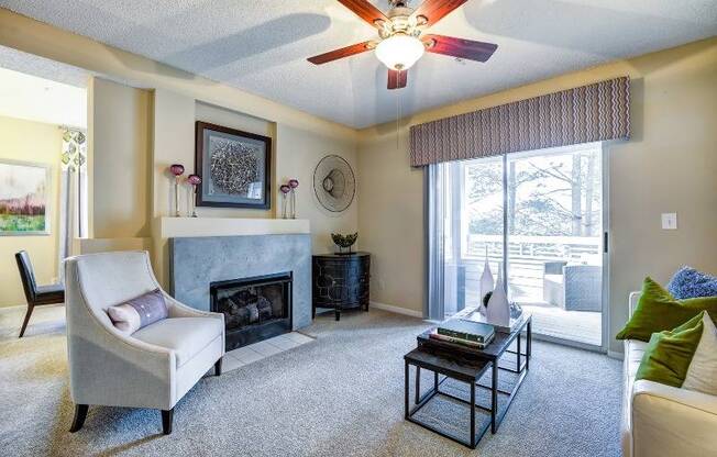 Classic living room with fireplace looking out to patio/balcony