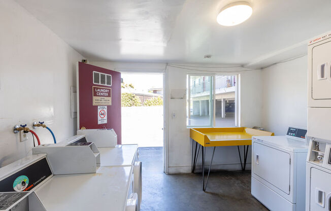 a kitchen with a sink and a yellow table