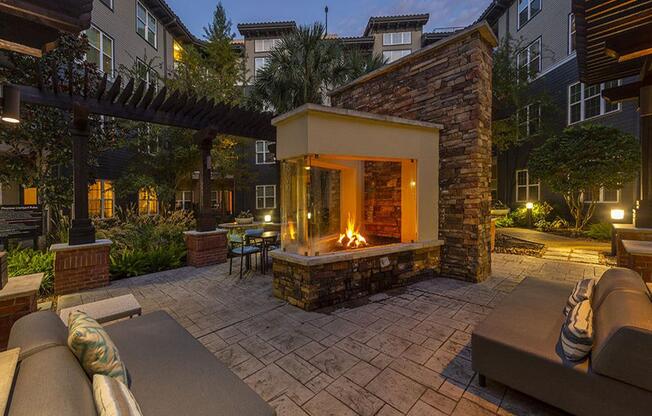 a backyard with a fireplace and a patio with furniture