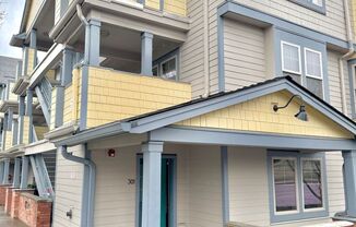 Gateway Ground Floor Corner Unit Condo with Laminate H/W's, A/C, Assigned Parking, Laundry In-Unit