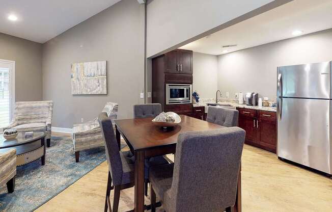 A modern kitchen with a dining table and chairs.