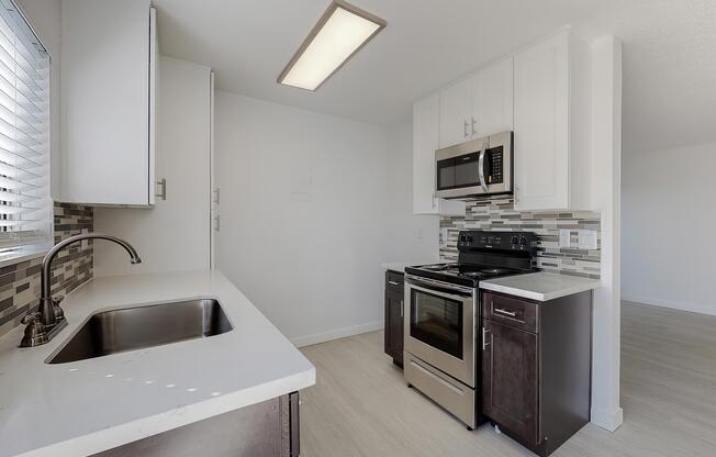 a kitchen with a sink and a mirror