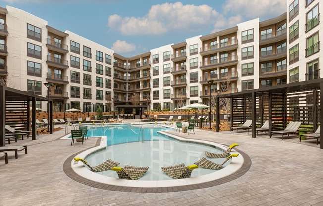 a large swimming pool in front of an apartment building