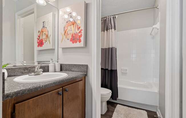 spacious bathroom with tub and shower, toilet, and sink