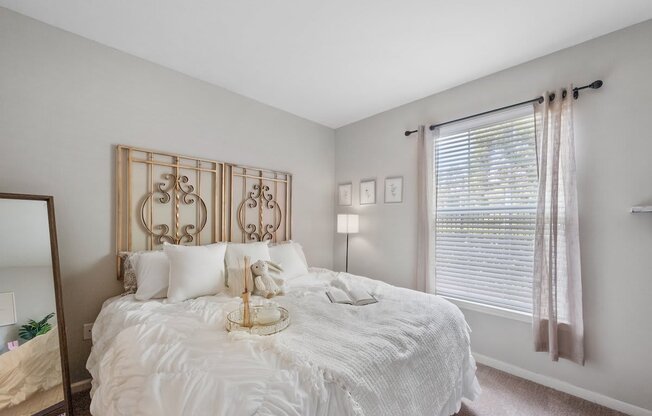 a bedroom with a large bed and a large window