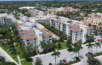 an aerial view of a city with buildings and palm trees