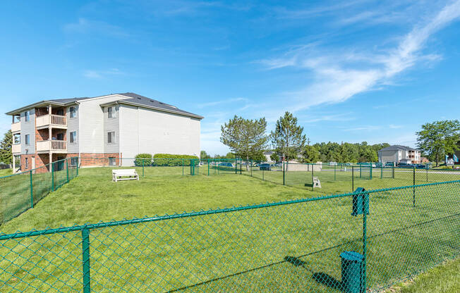 green lawn with green fence at mill pond dog park