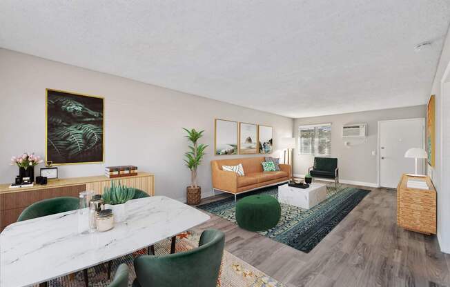 A living room with a white marble table and green chairs.