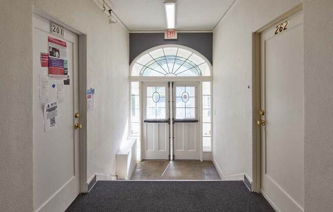 a hallway with a large window and two doors at MILEPOST 5 Apartments, Oregon, 97213