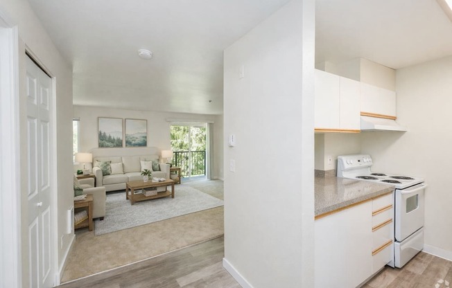 A white kitchen with a stove and a countertop.