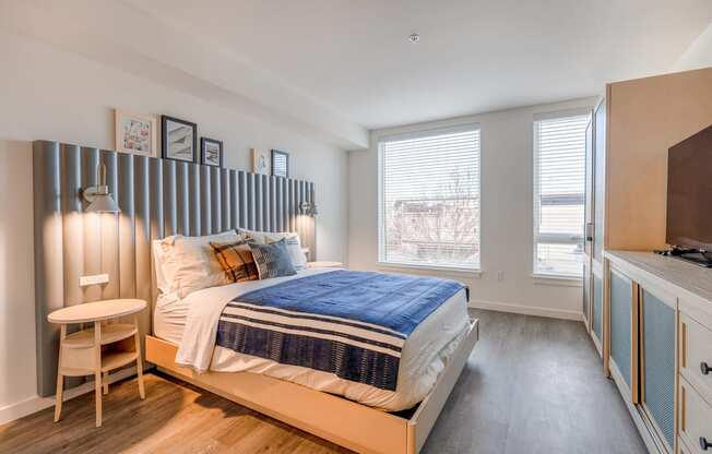 a bedroom with a bed and a desk with a chair at Marina Square, WA 98337