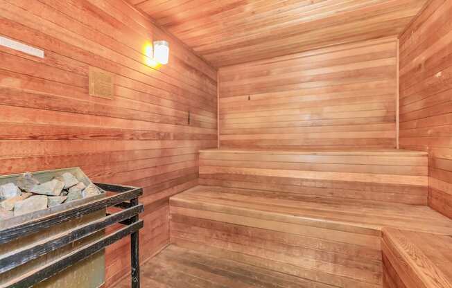 a wooden sauna with a bench and a table