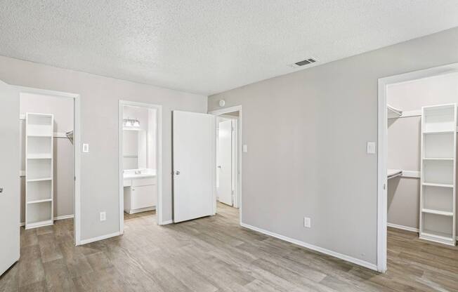 A6 bedroom with two walk-in closets at Windridge on the Parkway apartments in Dallas, TX