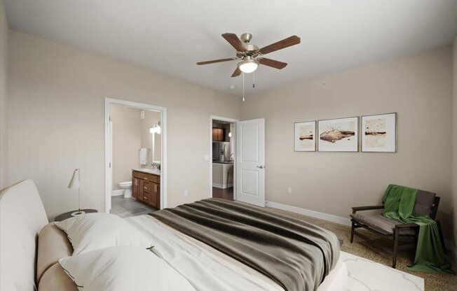 A bedroom with a large bed and a ceiling fan.