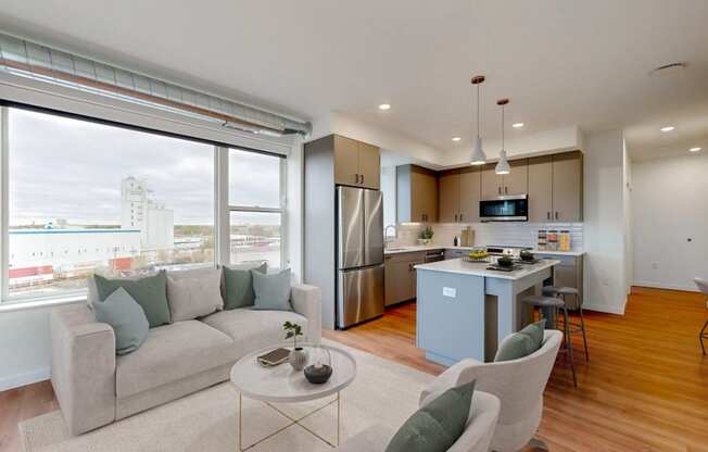 a living room and kitchen with a couch and a table